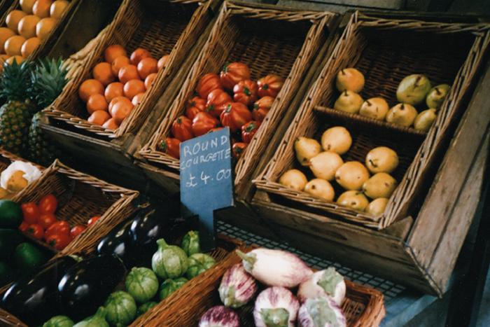 A photo of organic fruit and veg on sale in brown crates.